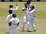 India's Ravichandran Ashwin celebrates after taking the wicket of South Africa's Lungi Ngidi with teammates to win the match.