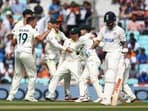 Scott Boland celebrates after taking the wicket of India's Virat Kohli with teammates 