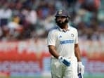 India's Rohit Sharma walks back to the pavilion after losing his wicket, caught out by England's Ollie Pope off the bowling of Shoaib Bashir 