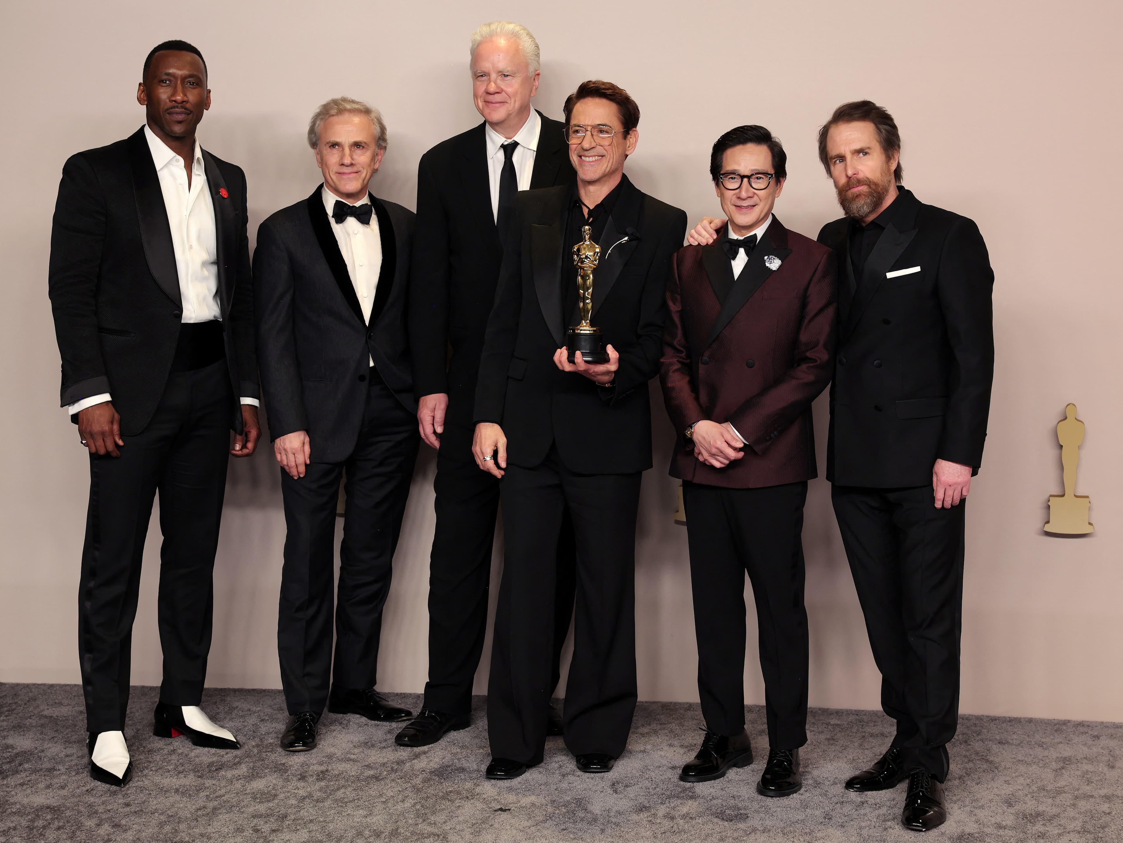 Robert Downey Jr. poses with the Best Supporting Actor Oscar for "Oppenheimer", along with Ke Huy Quan, Sam Rockwell, Mahershala Ali, Christoph Waltz and Tim Robbins, in the Oscars photo room at the 96th Academy Awards in Hollywood, Los Angeles, California, U.S., March 10, 2024. (REUTERS)