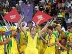 Australia's Mitchell Marsh celebrates with the trophy and teammates after winning the ICC Men's T20 World Cup