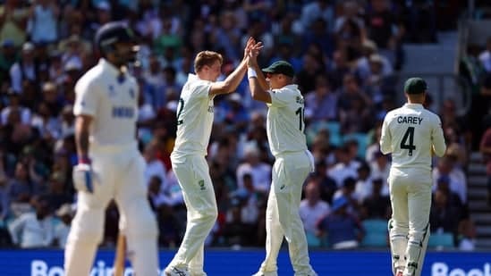 Australia's Cameron Green celebrates after taking the wicket of India's Cheteshwar Pujara with Scott Boland