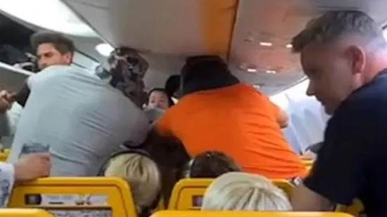 Two passengers were seen on film exchanging blows on a Ryanair aircraft from Malta to London after a brawl broke out over access to a window seat.(Newsflare)