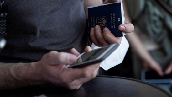 A Ukrainian man seeking asylum in the United States holding his passport.(Reuters)